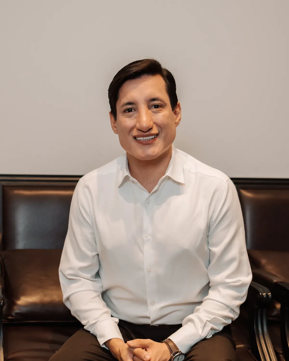Dr. Diego Torrico seated, wearing a white shirt